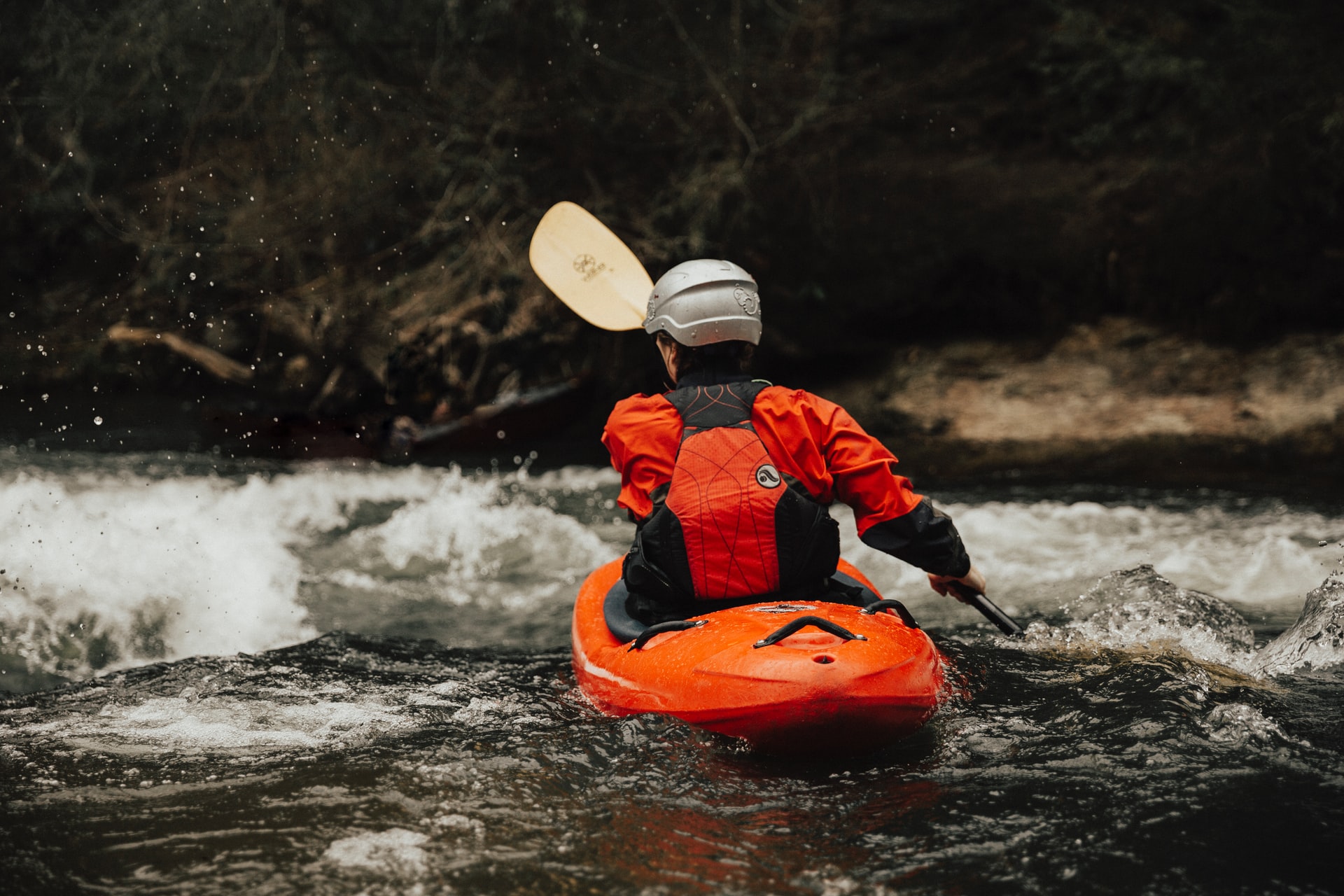 person water rafting on body of water